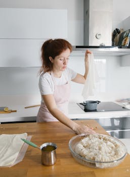 A woman with red hair prepares dough in a modern Istanbul kitchen.