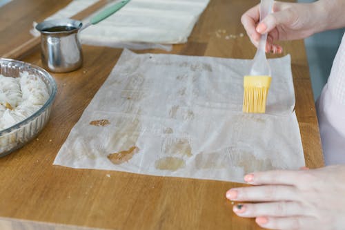 Free A Person Brushing a Phyllo Dough Stock Photo