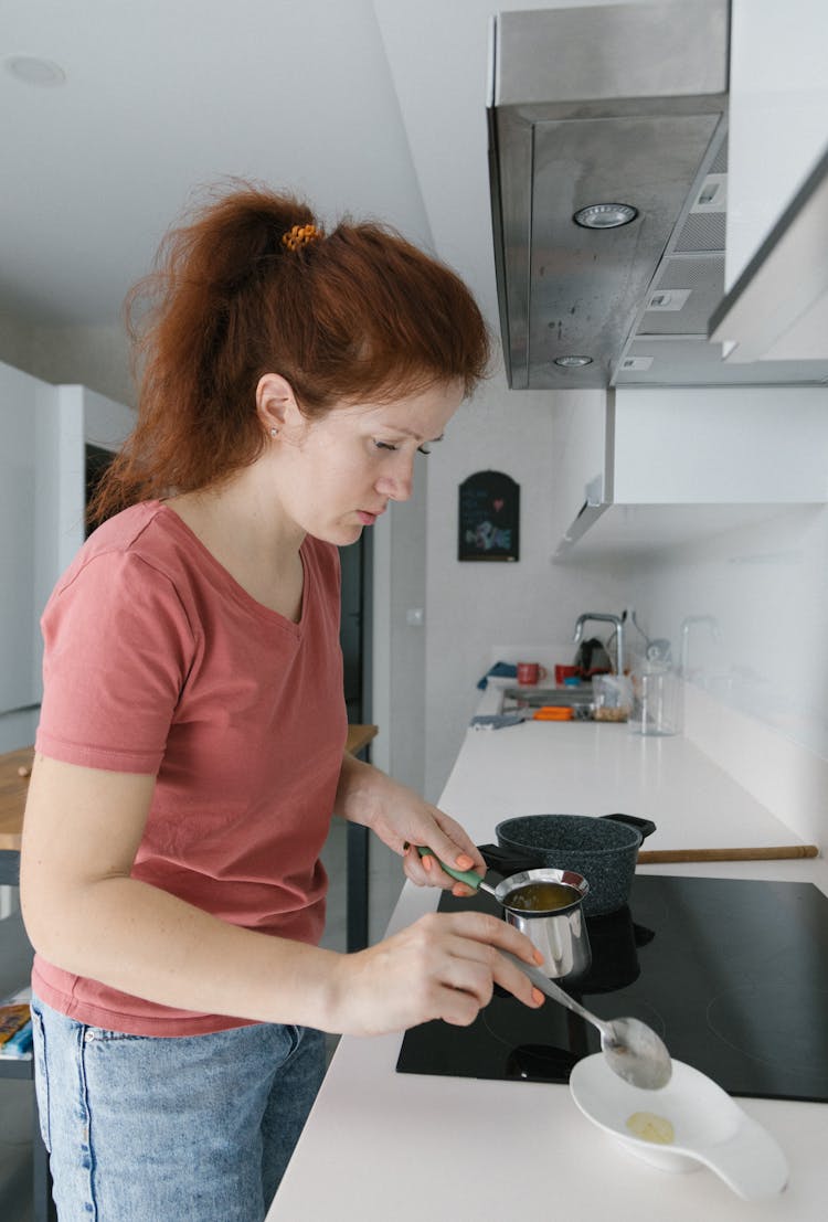 A Woman Cooking In The Kitchen