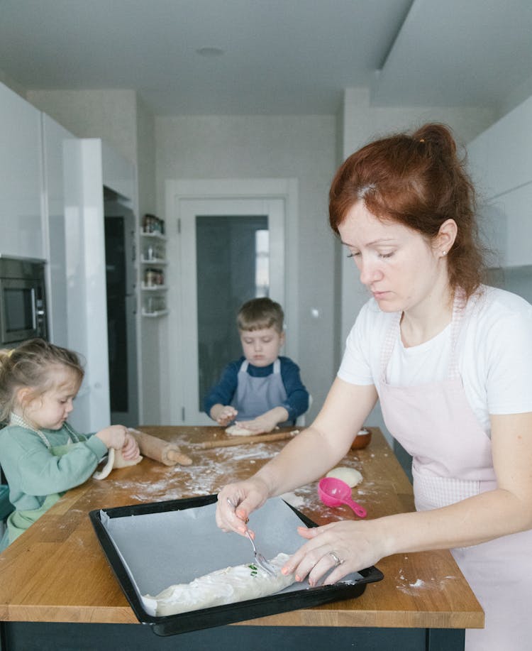 Woman Cooking With The Kids