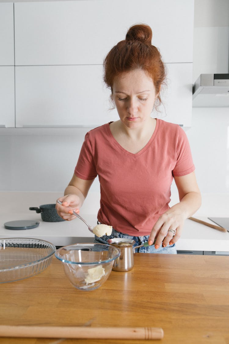 A Woman In A Pink Shirt Cooking