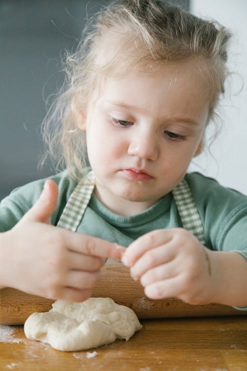 Child Holding a Dough