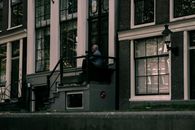 An Elderly Man Sitting on the Building Stoop