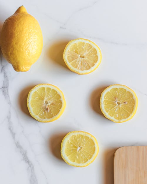 A Sliced Lemon on White Surface