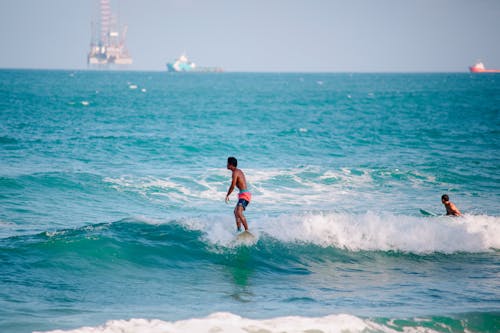 Men Surfing on the Beach