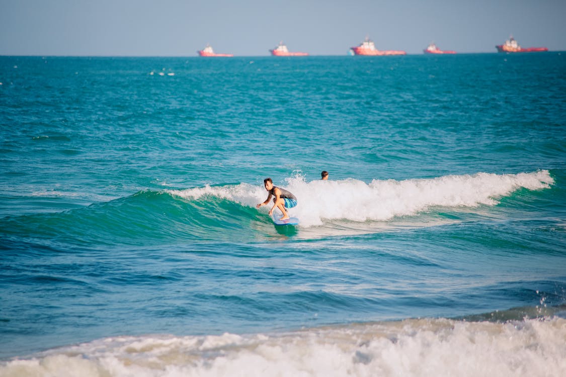 A Surfer Riding on Sea Waves · Free Stock Photo