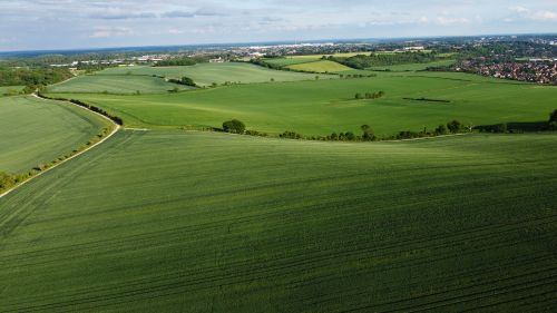 Free Aerial drone view of lush green fields in Central Bedfordshire, England, showcasing beautiful landscapes and rural scenery. Stock Photo