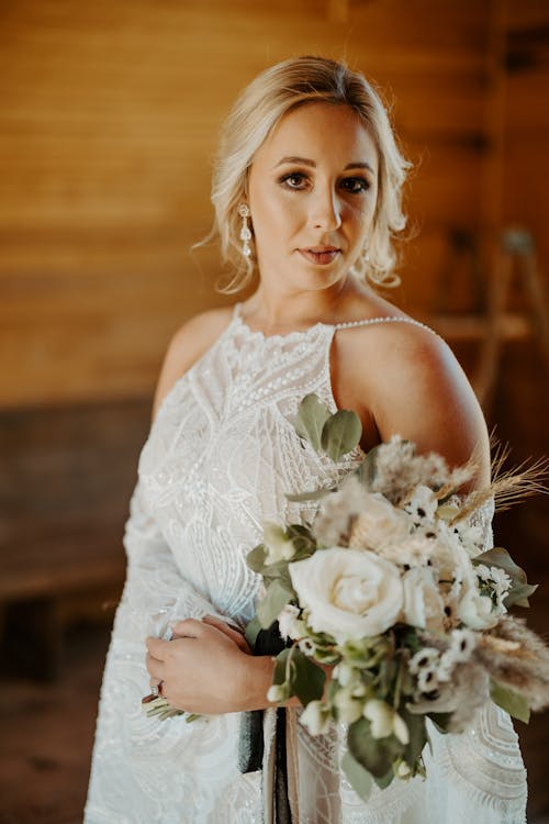 A Beautiful Bride Holding a Bouquet of Flowers