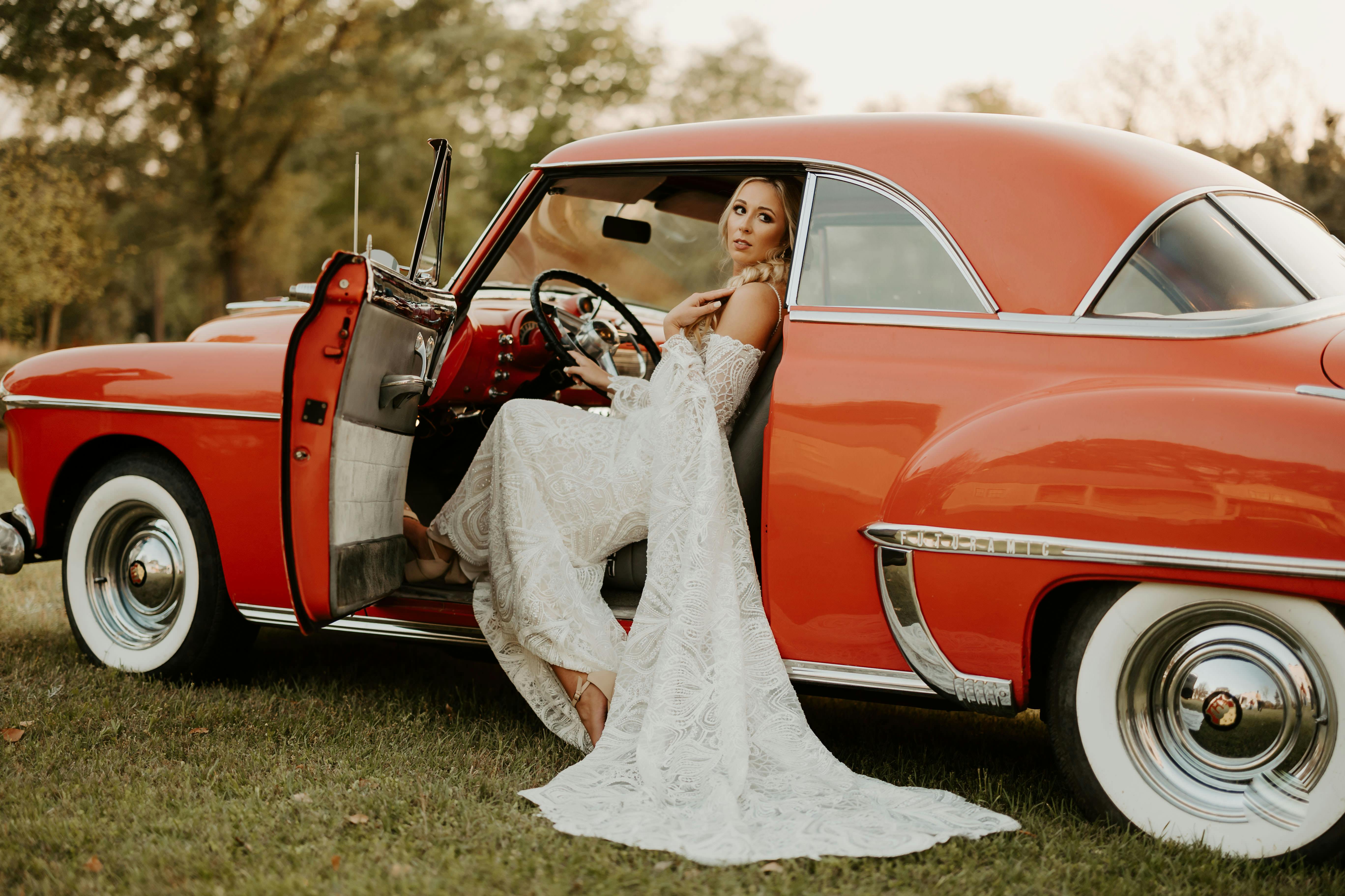 A Beautiful Woman in a Vintage Car · Free Stock Photo