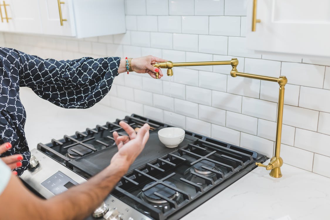 Free A Person Holding A Brass Faucet Tube Stock Photo