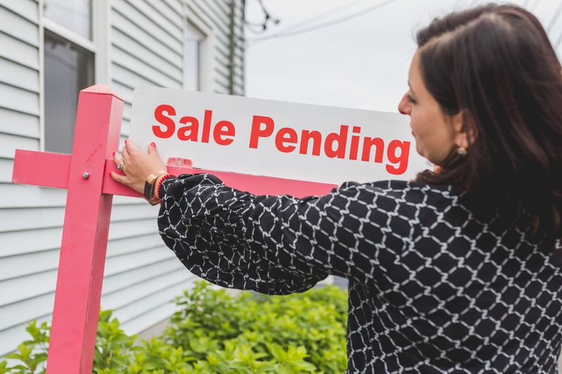 Person reviewing mortgage documents with calculator