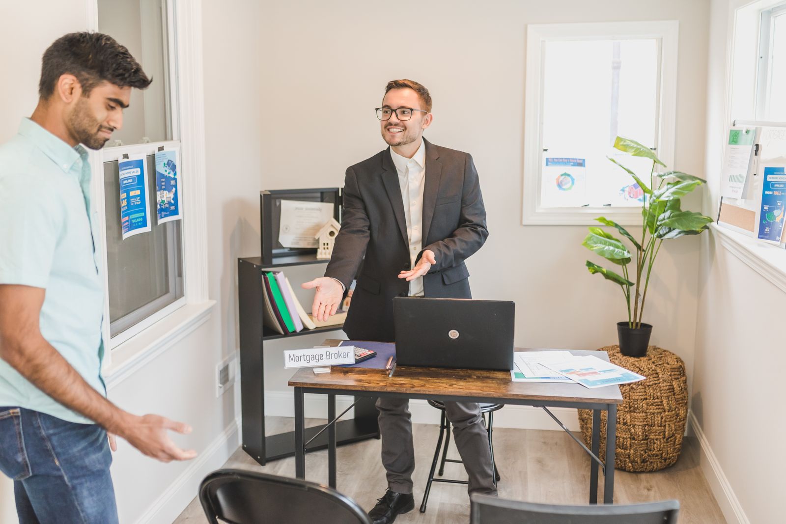 Free A professional business interaction in a modern office with a mortgage broker and client. Stock Photo