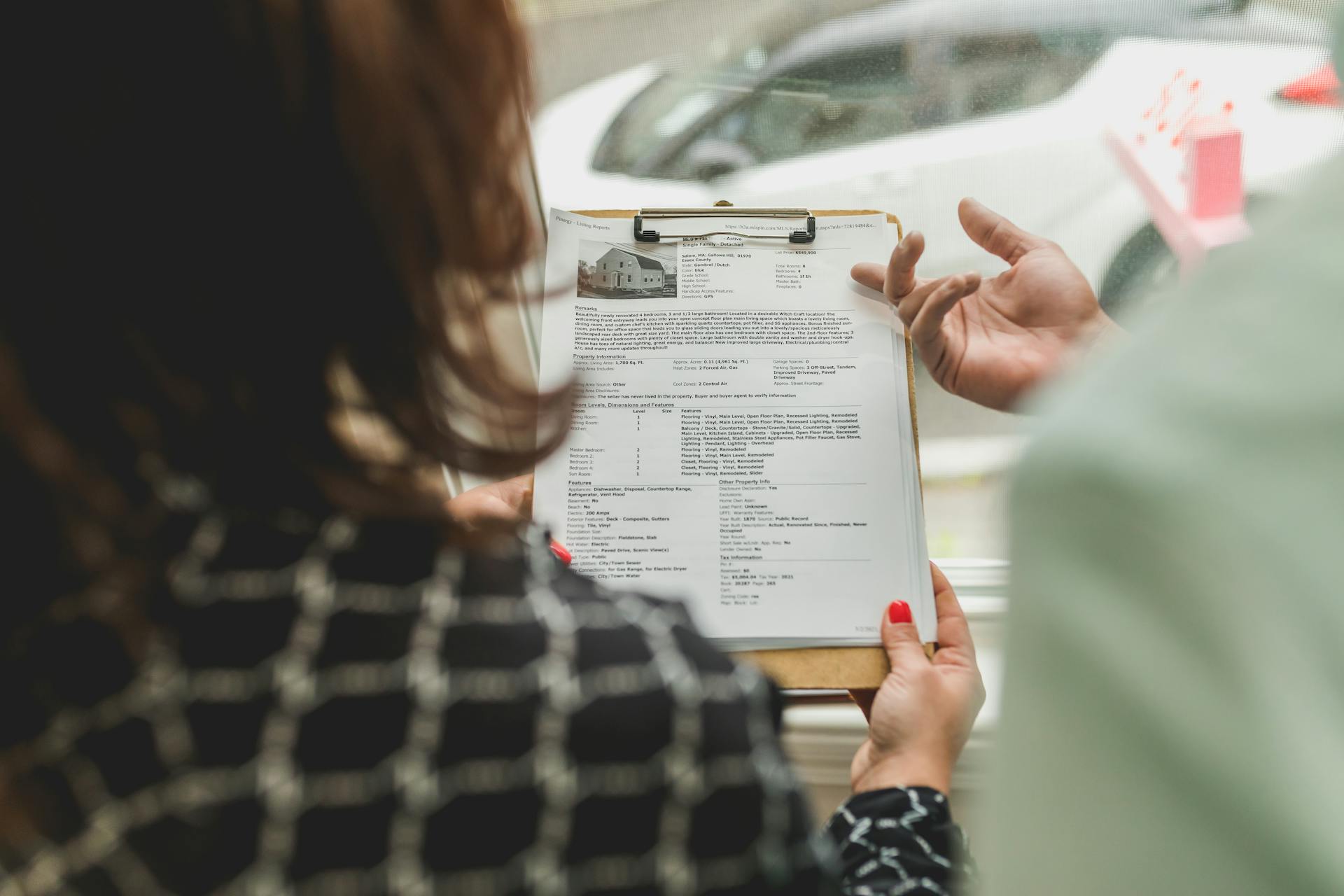 Real estate agent reviewing property documents with a client.