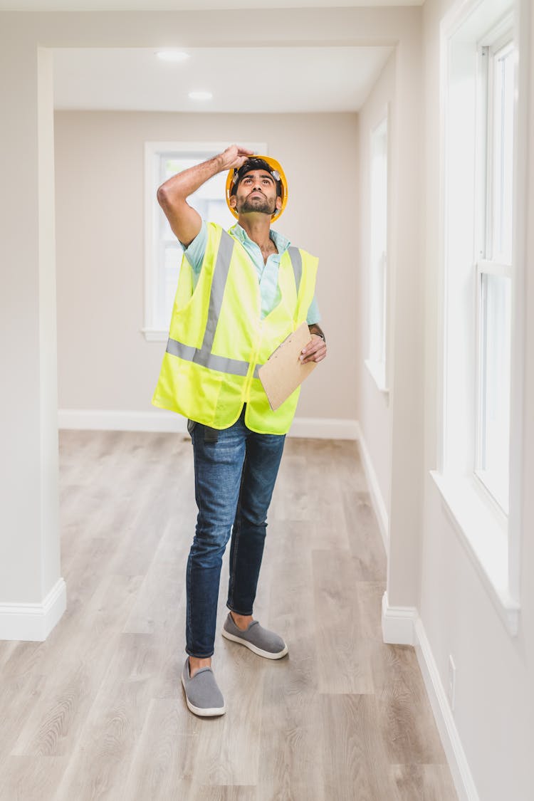 A Man Inspecting The House Interior