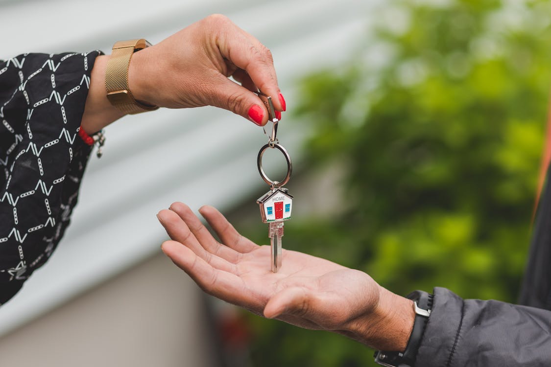 Free A Person Holding a Key Stock Photo
