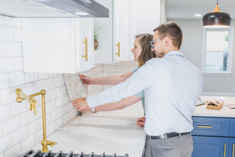 A Couple Picking A Design For The Kitchen Backsplash