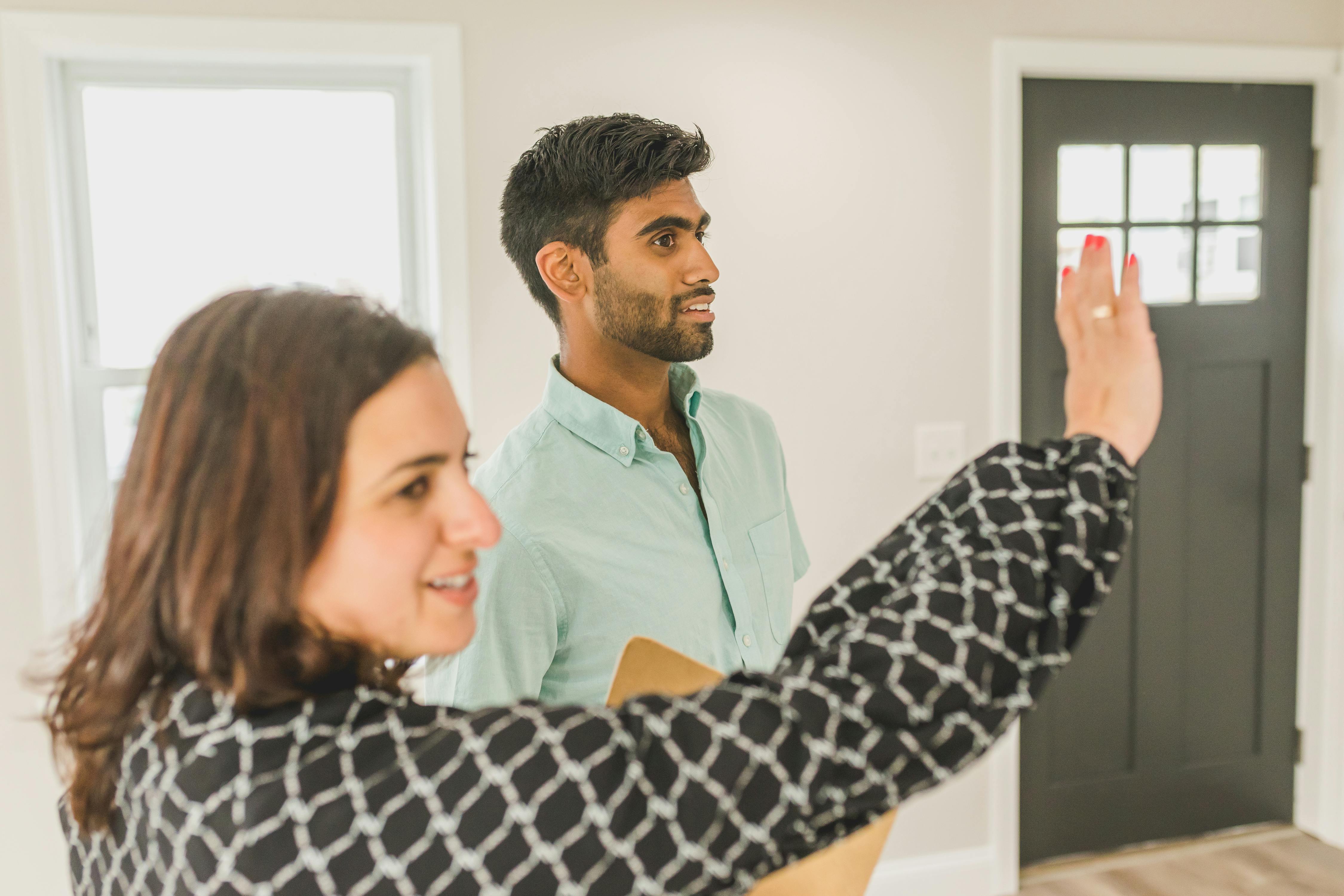 a real estate agent giving a house tour to a client