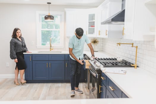 Real estate agents inspecting a modern kitchen interior for potential sale.