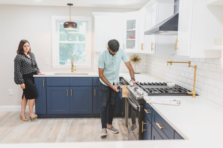 A Man Inspecting The Kitchen Drawer