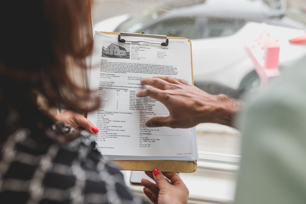 Person reviewing housing documents and making checklist