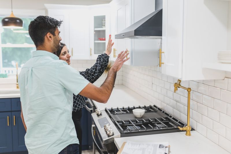 Real estate agent showing a modern kitchen during a home tour