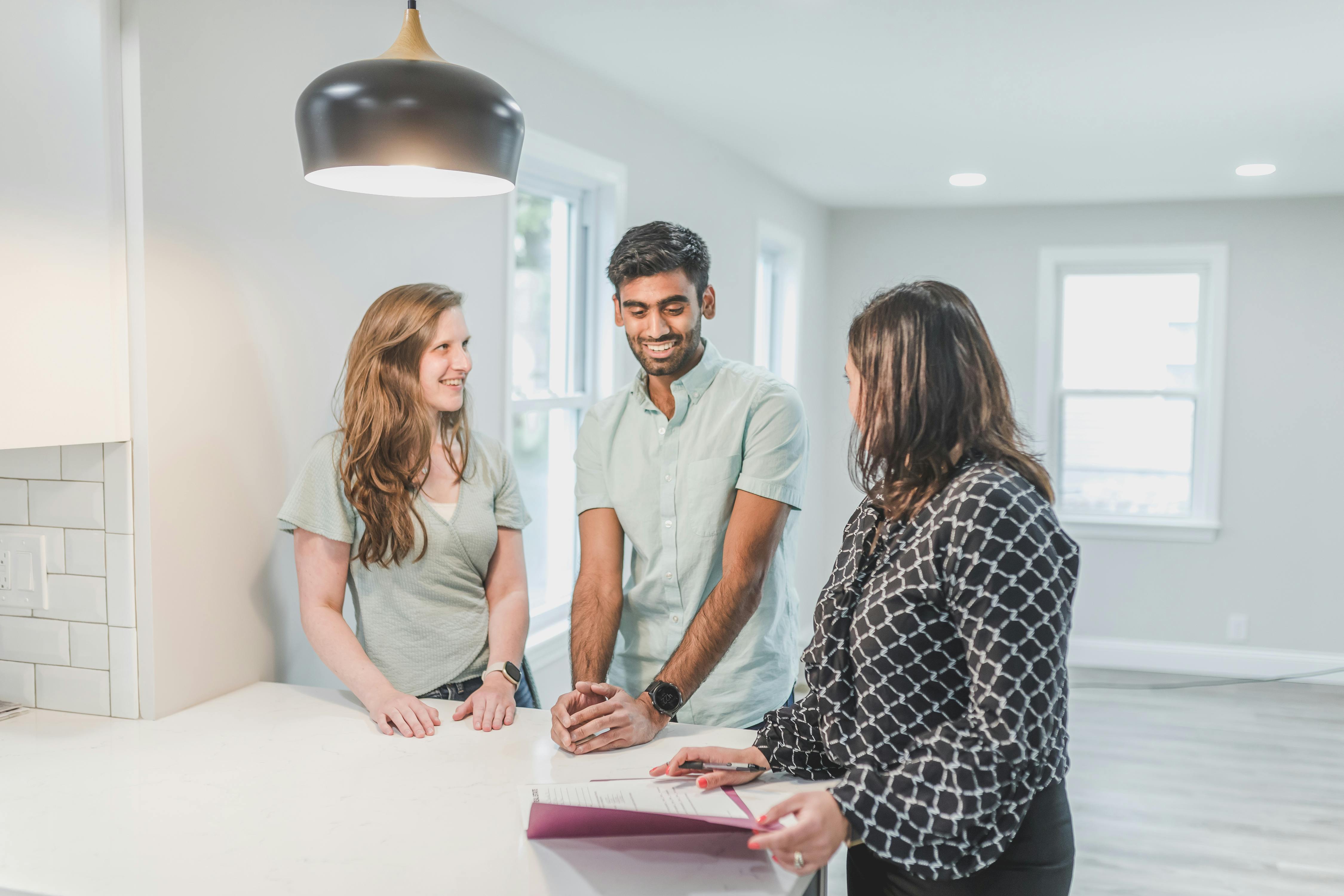 a man and woman standing beside a table with a person