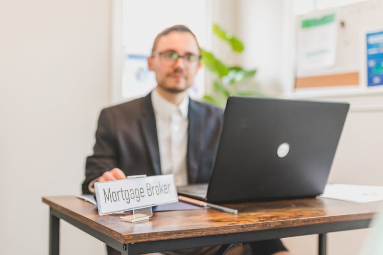 A Mortgage Broker Sitting Behind A Desk