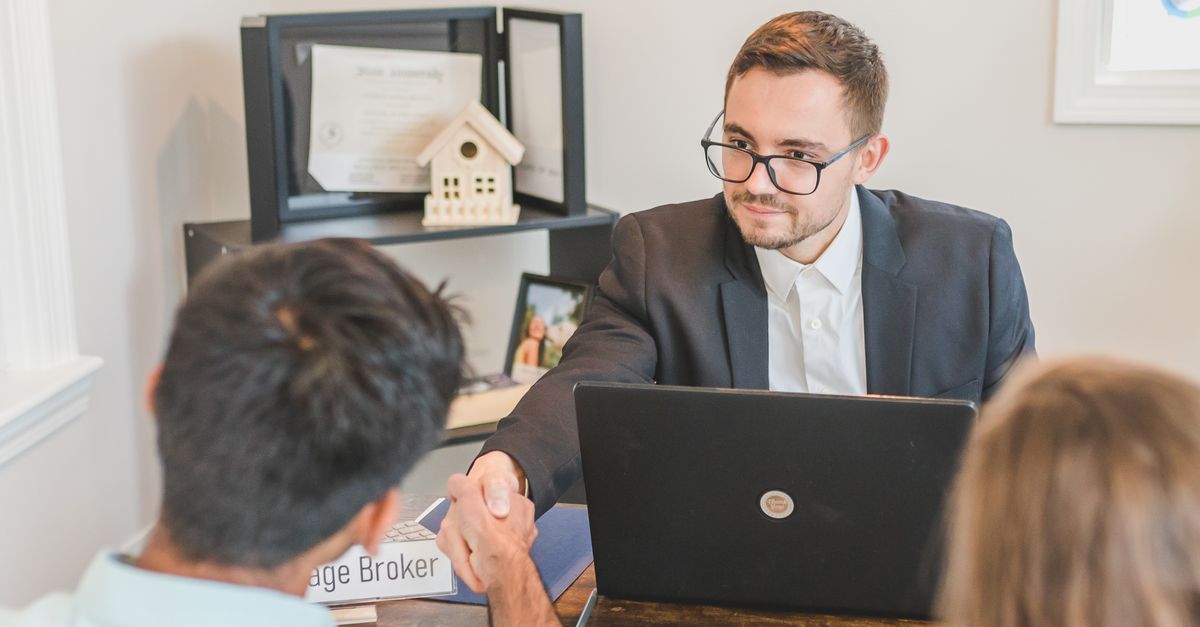 A couple reviewing a mortgage renewal with an advisor as low pandemic era rates come up for renewal