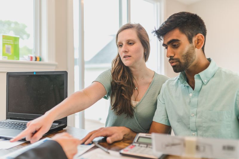 A young couple reviewing real estate documents