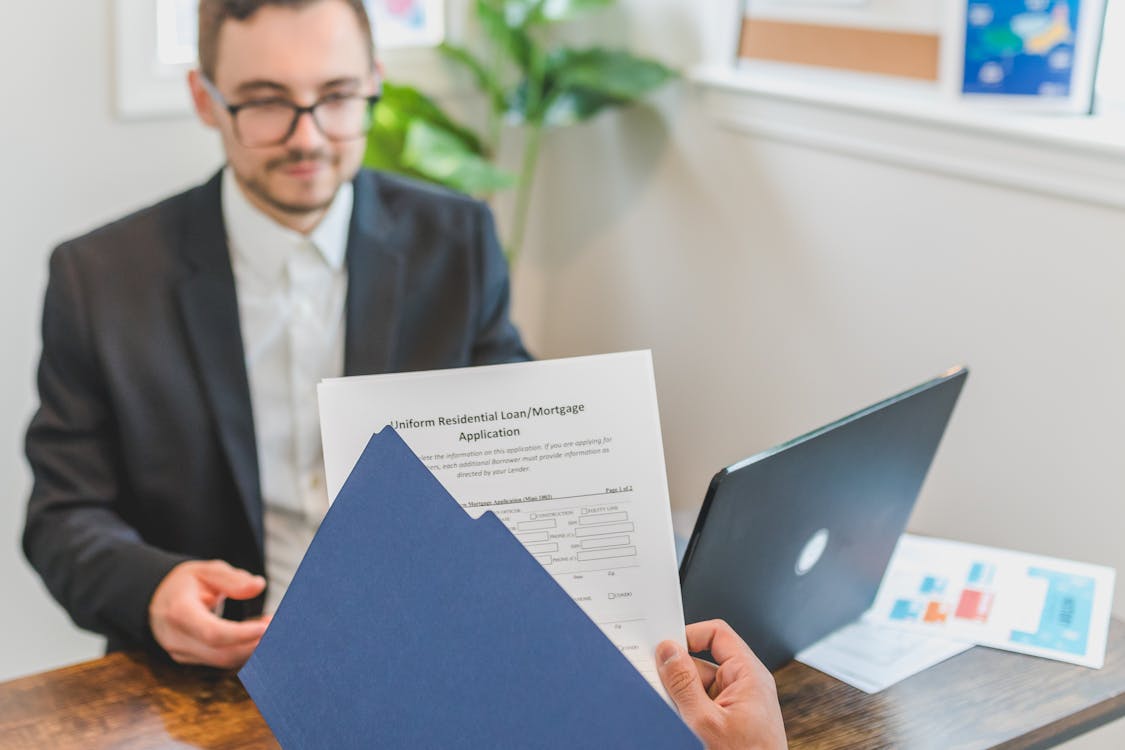 Free A Person Holding Loan Documents Stock Photo