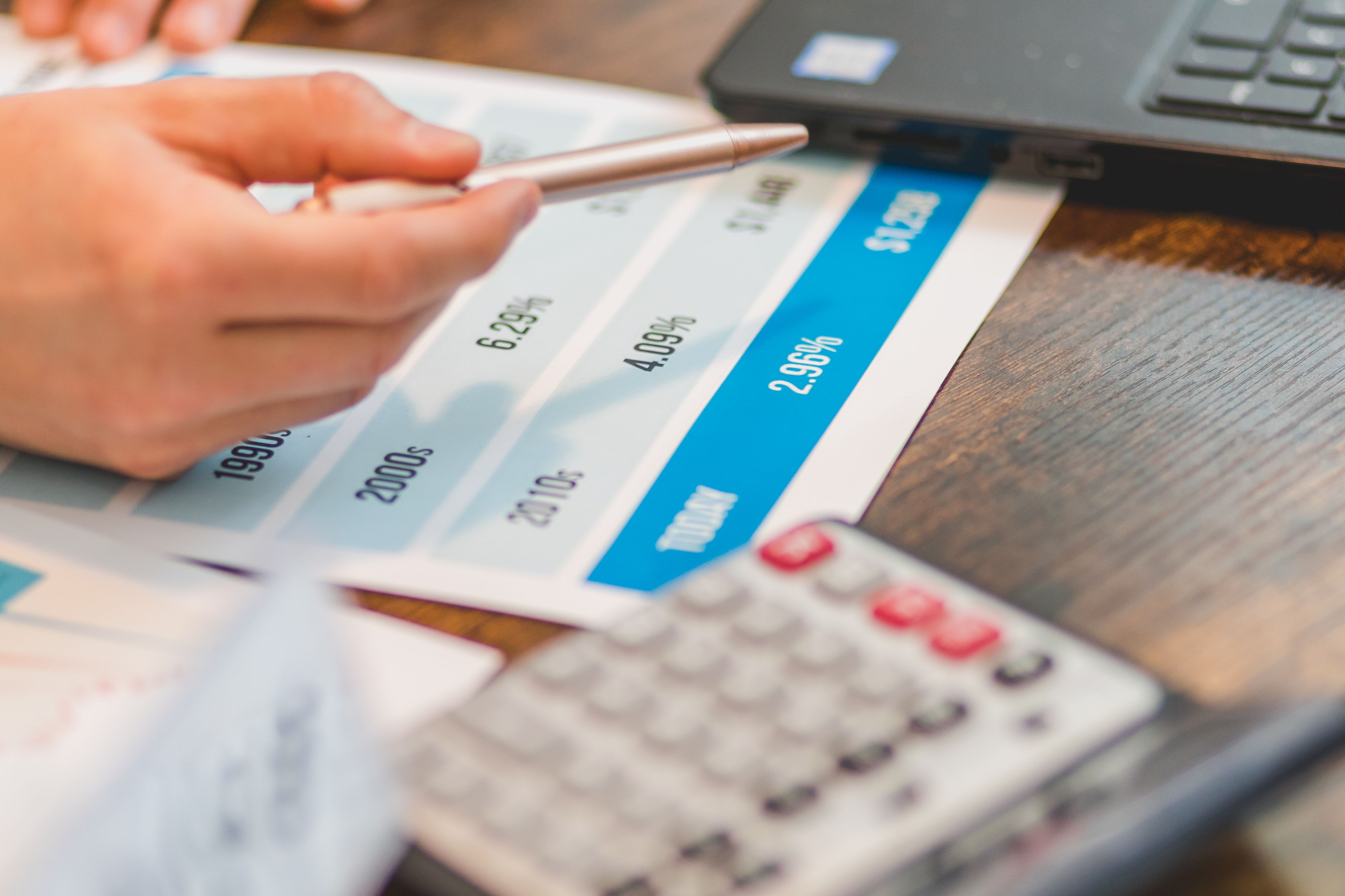 an agent pointing at real estate rates with a ballpen