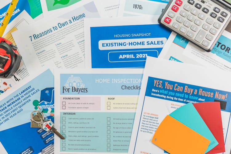 Assorted Brochures And Flyers On Near A Calculator