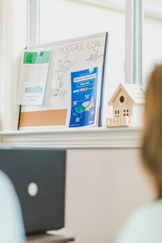 Financial board with mortgage rates and home sales data in a bright office.