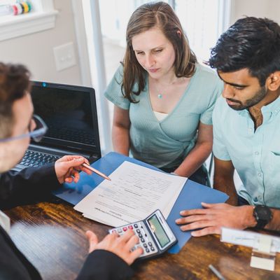 Real estate agent discussing an ownership agreement with a couple