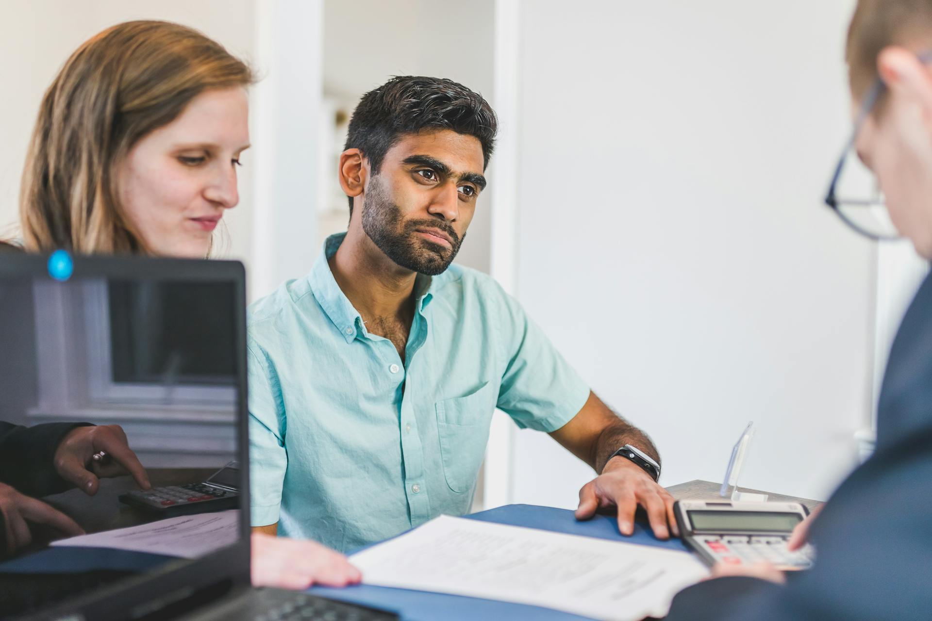 Diverse team discussing business strategies in a modern office setting.