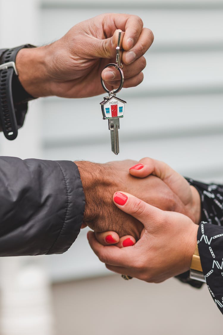 Person Handing Over A Key