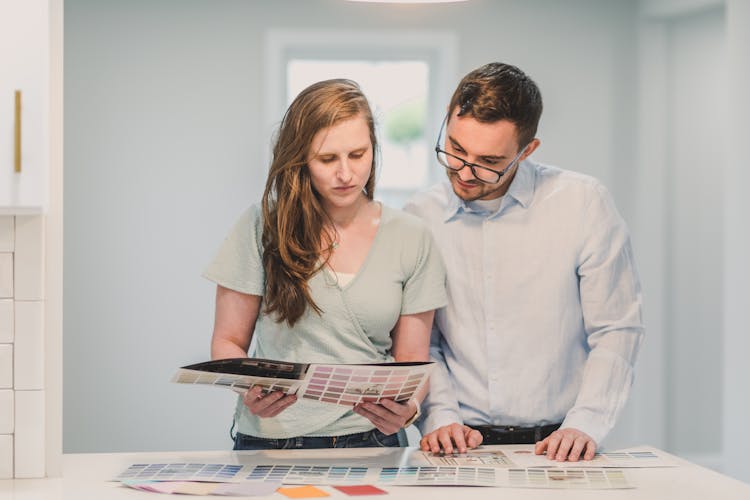 A Man And A Woman Reading The Colored Catalog 