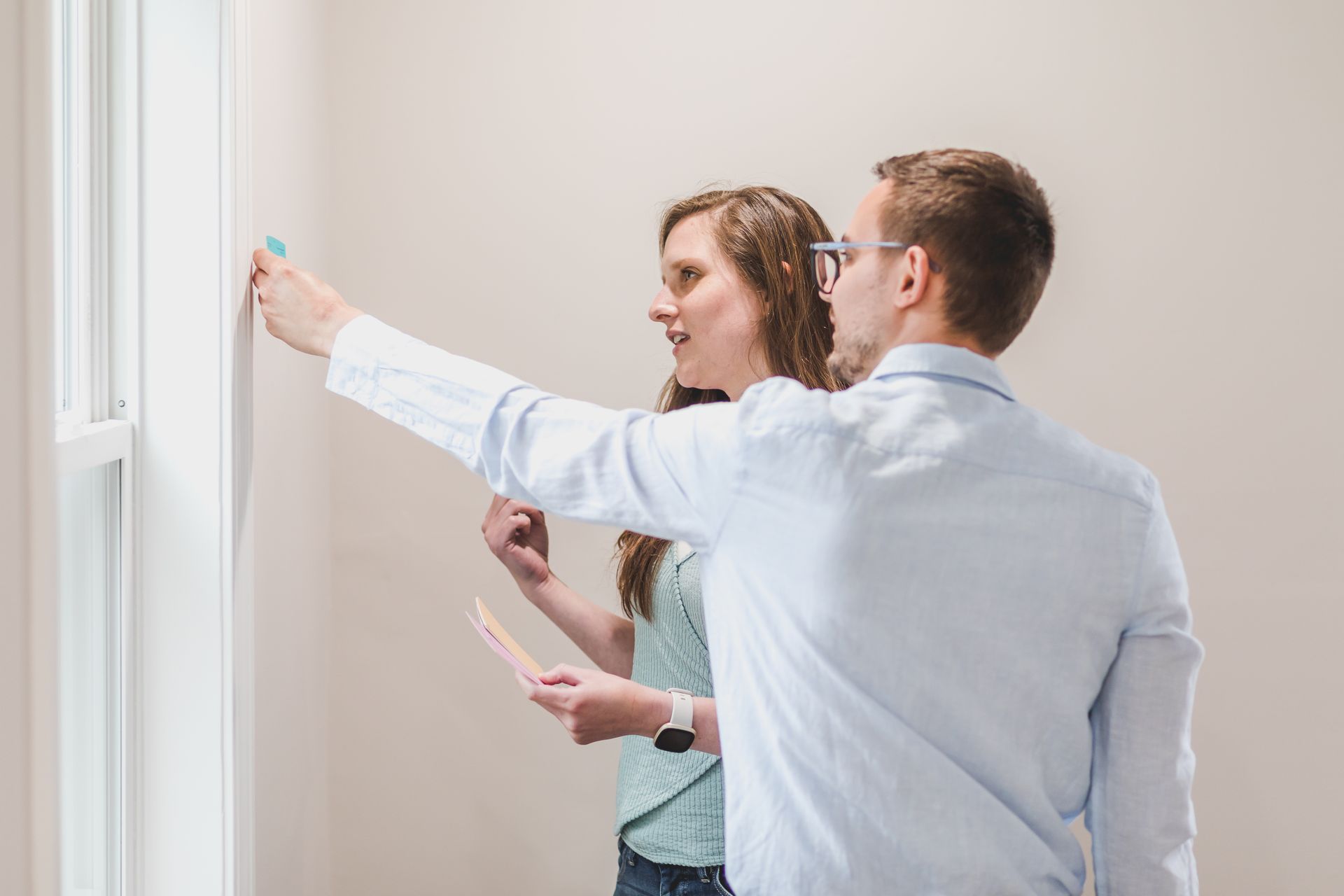 Man and Woman Choosing Paint Color of Wall