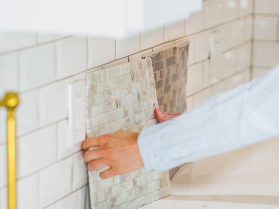 Tradesman installing tiling during a renovation