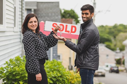 Real Estate Agent Handing the Key to Her Client