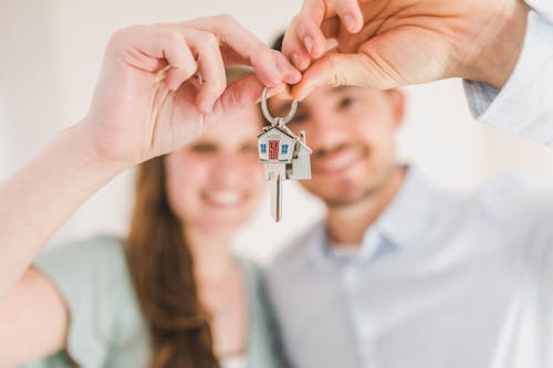 Free Happy Couple Holding and Showing a House Key