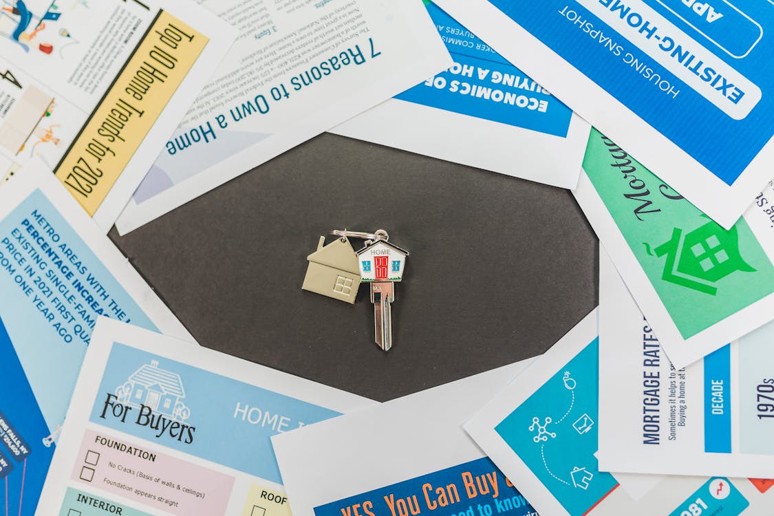 Free House Key with Paper Leaflets on a Table Stock Photo