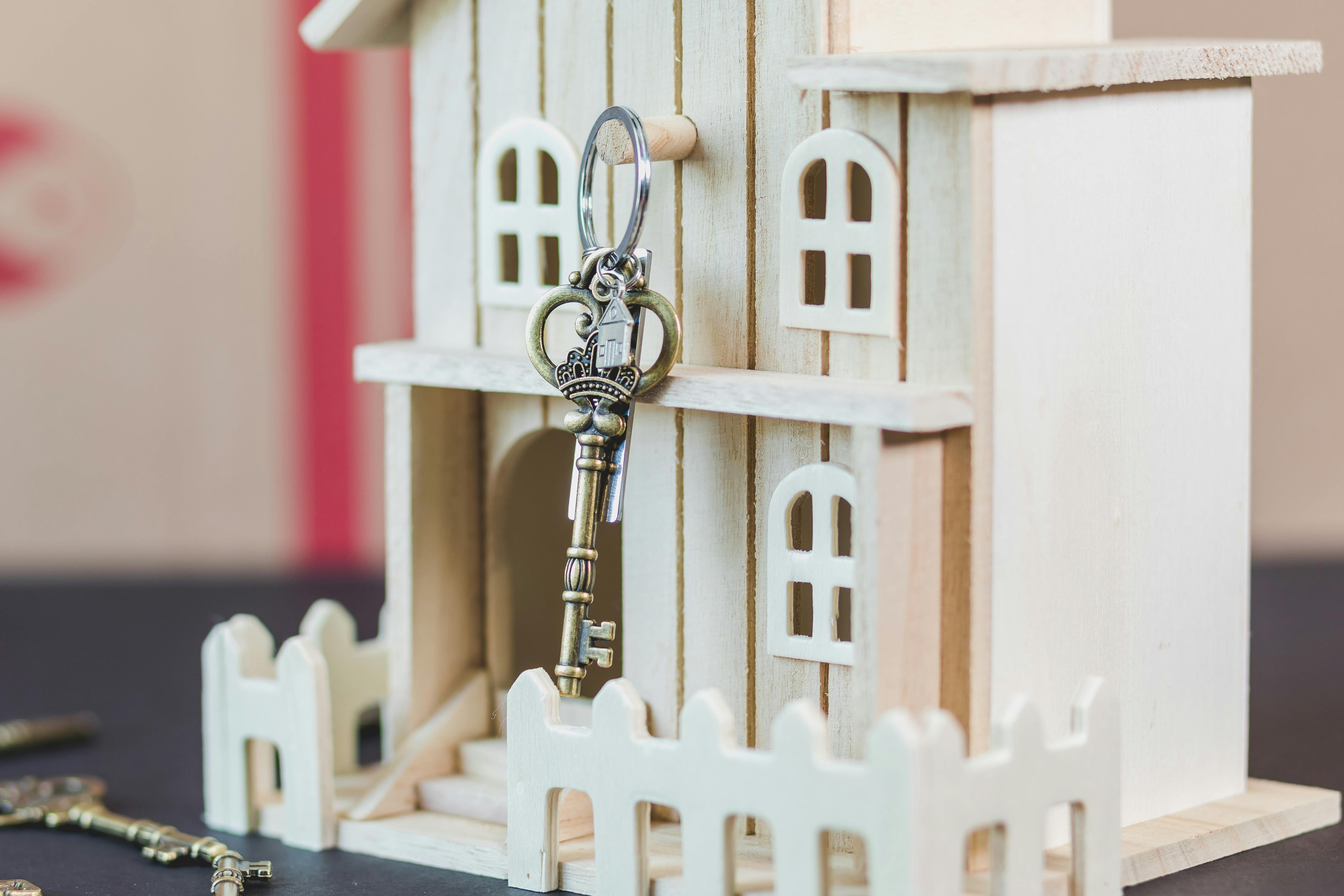 key hanging on wooden doll house