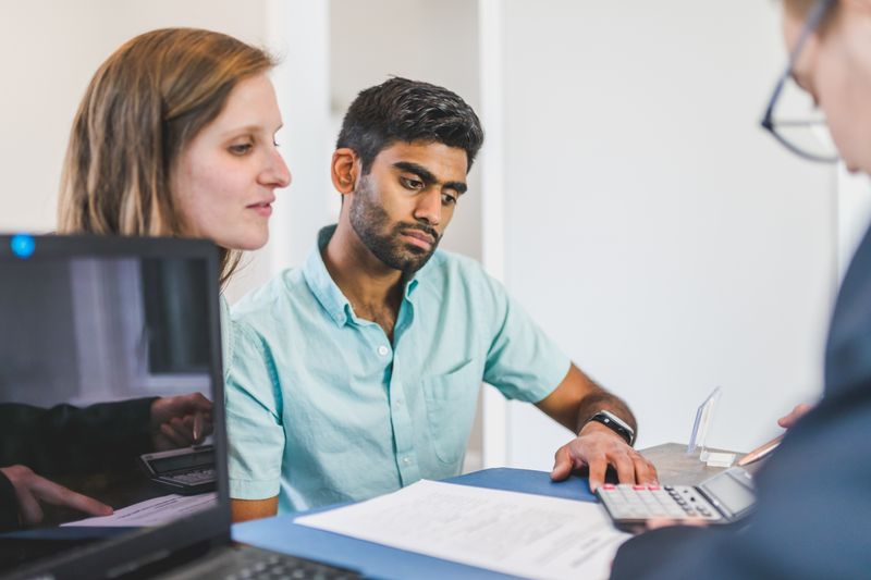 Financial advisor reviewing an education savings plan with parents