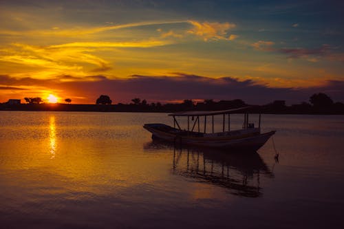 Wooden Boat on the Lake During Sunset