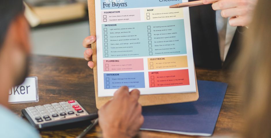 A person holding a clipboard with documents — four questions to ask before booking pest control