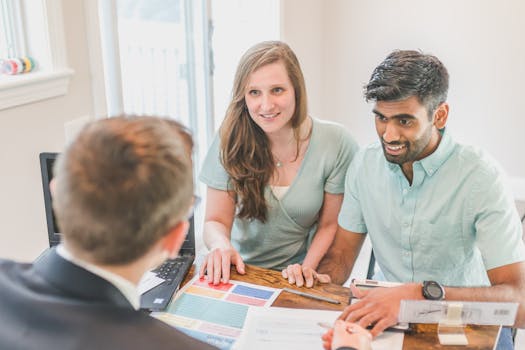 A real estate agent discussing property details with a couple, showcasing diversity and communication indoors.