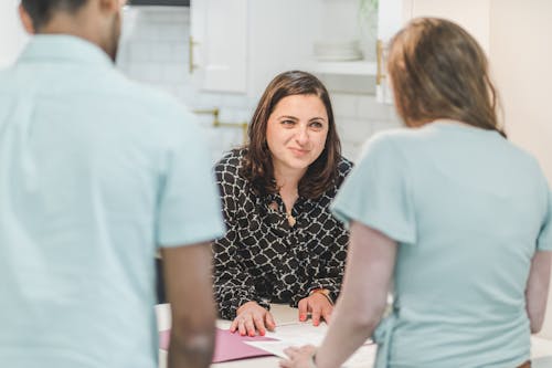 Real Estate Agent Discussing in Front of Her Client