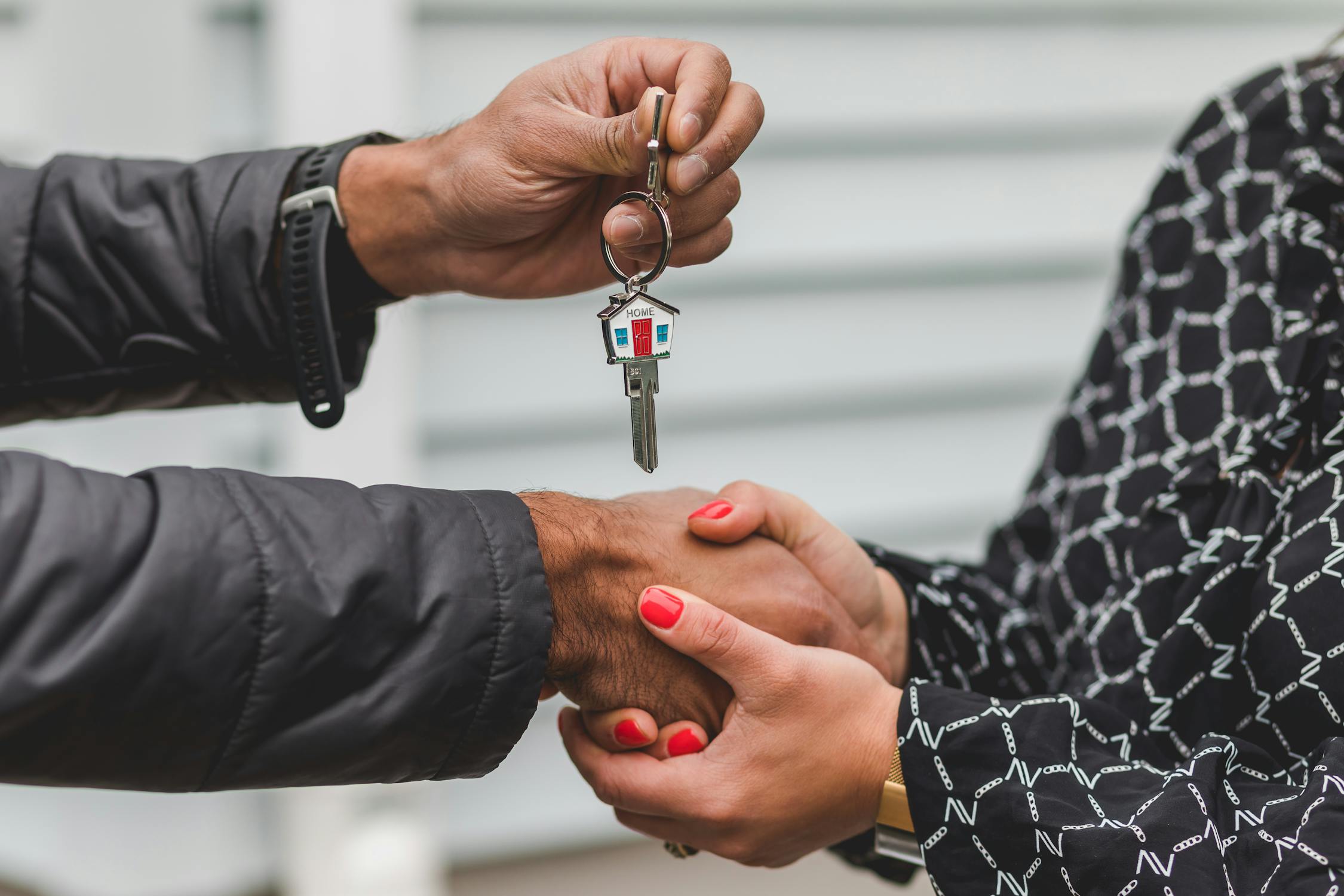 A person handing over a house key