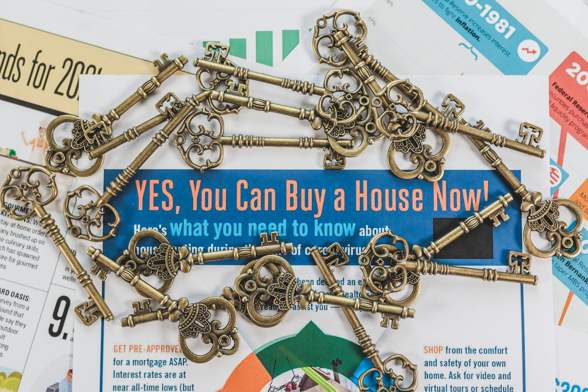 Vintage keys spread over real estate documents symbolizing property ownership and investment.